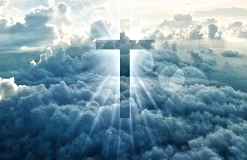 Christian cross appears bright in the sky background